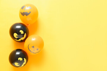 Funny Halloween balloons on yellow background