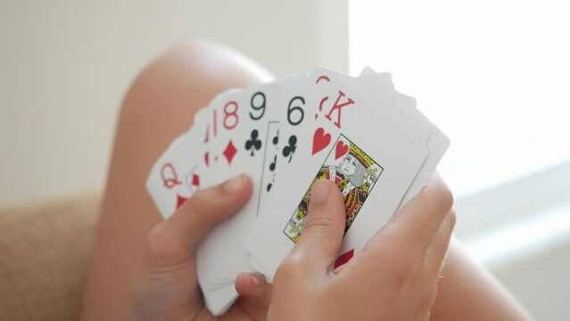 Teenager holds a deck of cards in his hands
