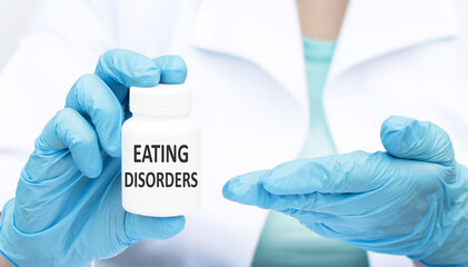 eating disorders inscription on the label on the can in the hands of a doctor in blue gloves. Medical concept.