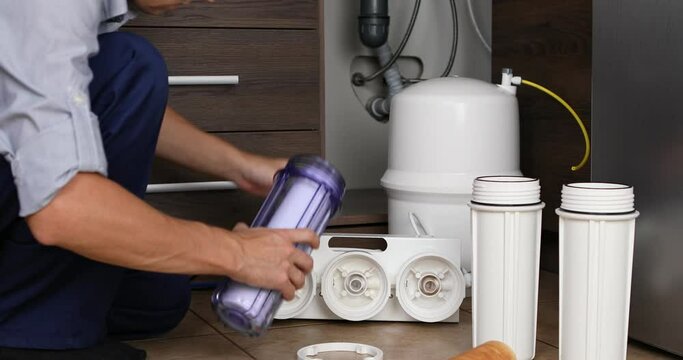 Plumber change the filter element in the water filter