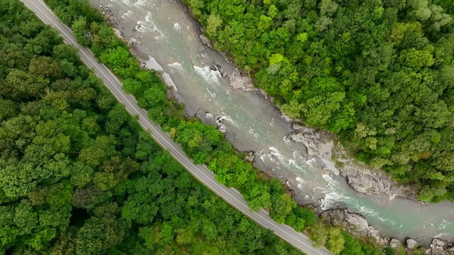 Aerial view of Mountain river and road. Flying over a mountain gorge. Slow motion video, ProRes 422