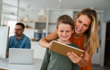 Distance learning, online education, home work concept. Family with digital devices at home. - obrazy, fototapety, plakaty