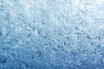 The texture of the ice surface. Winter background, festive background in the form of ice crystals, in natural deep blue color.