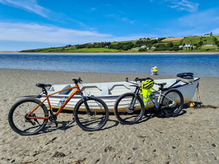 Concept of enjoying the outdoors by bicycle and boat at Gweebarra Bay , County Donegal - Ireland