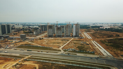 Fototapeta premium Construction site of a new city block. Construction of multi-storey buildings. Overcast weather. Aerial photography.