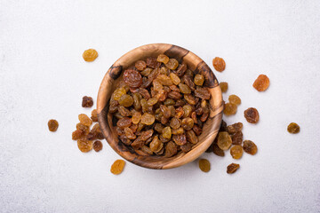 Wooden bowl with raisins as ingredient for tasty dessert