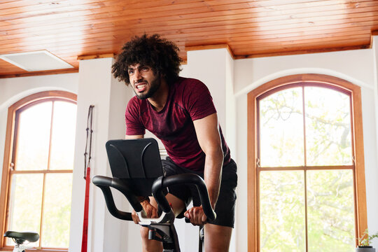 Young Middle Eastern Man Doing Intense Cardio Workout On Exercise Bike At The Gym