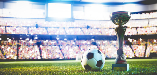 Football soccer ball and trophy cup on stadium