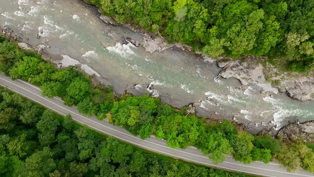 Aerial view of Mountain river and road. Flying over a mountain gorge. Slow motion video, ProRes 422