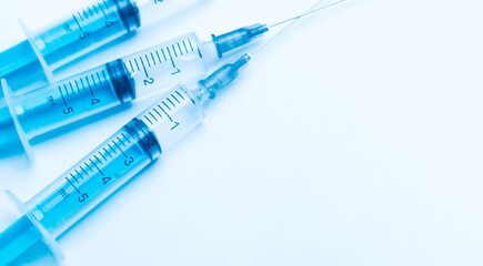 Obraz premium medical disposable syringe with needle for injection in the hospital. medical devices on a white background. virus protection concept