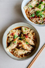 Homemade Chinese cuisine. Jiaozi Dumplings in Sichuan Mala Gravy or Noodle. Tasty and savory with spicy and tongue numbing sensation. Dumplings wrapped with ground pork and shrimp and water chestnut