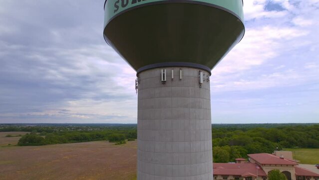 A ascending aerial drone shot of a water tower in Lee's Summit Missouri