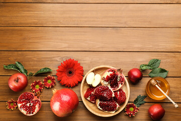 Flat lay composition with Rosh Hashanah holiday attributes on wooden table. Space for text