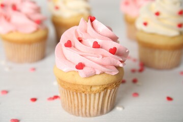 Tasty sweet cupcakes on white table. Happy Valentine's Day