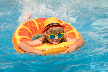 Kid boy relaxing in pool. Child swimming in water pool. Summer kids activity, watersports. Summer vacation with children.