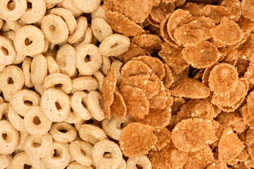 Close-up of wheat flakes and corn rings, top view.