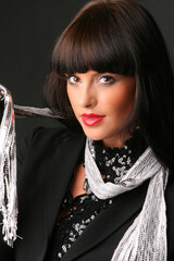 Portrait of a beautiful fashion girl brunette in the studio in blackleather  suit retro 90s vintage...