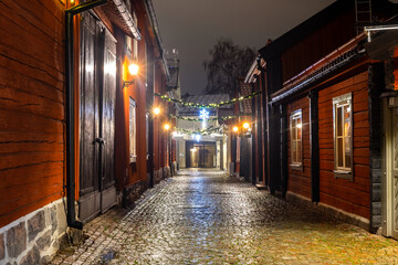Street of an old Swedish town with wooden traditional houses and Christmas decorations