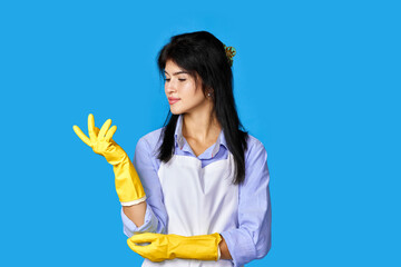 caucasian woman in rubber gloves isolated on blue background.