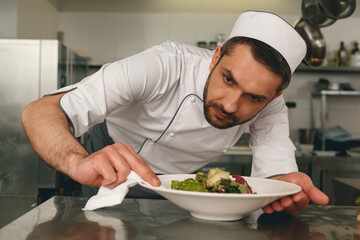 Chef preparing salad in the modern kitchen of restaurant. Tasty and healthy food