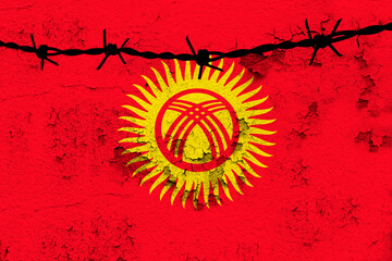 national flag of Kyrgyzstan flutters on wall with cracks, barbed wire, weapon drawing, concept of war, revolution, armed uprising in the country, gangster shooting, terrorist attack