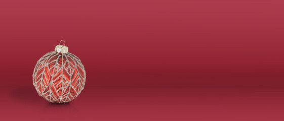 Red Christmas ball on red background. Copy Space. Christmas banner.