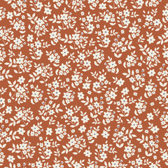 Vintage floral pattern with small white flowers and leaves on a terracotta background. Seamless pattern for design and fashion prints.Stock vector illustration.