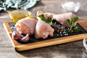 Raw chicken meat legs on cutting board