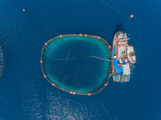 Bird's eye view of fish farming and a fishing boat