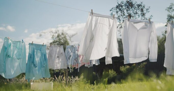 Wet clothes after washing dry in the backyard of the house.