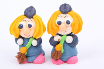 Doll made of colored sugar isolated on white