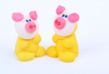 Doll made of colored sugar isolated on white