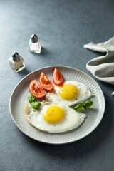Roasted eggs with tomatoes and basil
