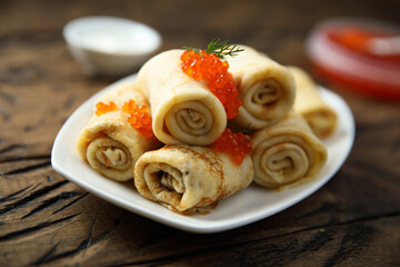 Traditional homemade crepes with red caviar