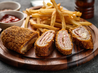Fototapeta na wymiar Fried chicken Cordon bleu with cheese and ham in breadcrumbs with french fries.