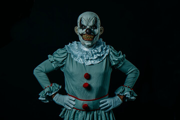 creepy evil clown with with hands on hips