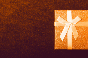 Gift box with a bow on a black background. Gift card with a place for text