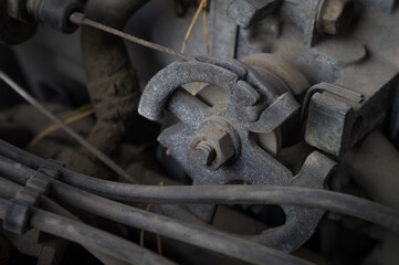 The throttle mechanism of the old car engine. Close-up of the throttle drive gear. Dirty parts of...