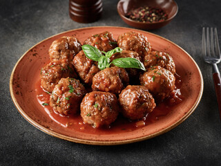 Homemade meatballs with tomato sauce and spices served in plate on grey background - 532710465