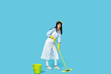 woman in rubber gloves and cleaner apron with cleaning supplies