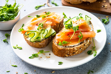Open sandwich with cream cheese, salmon and cucumber. Healthy breakfast or snack. close up.