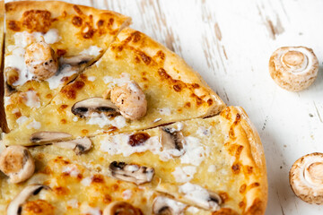 Tasty fresh baked pizza with champignons and chicken fillet