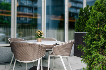 Table and comfortable chairs near cafe outdoors