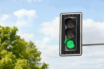 Traffic light against blue sky, space for text