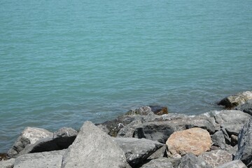 Fototapeta na wymiar Beautiful view of sea coast with stones on sunny day