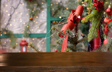 Christmas background. Empty wooden table on background of christmas decorated branch and christmas porch with golden bokeh. Ready for product montage. Mockup