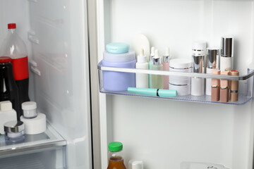 Different cosmetic products on shelves in refrigerator