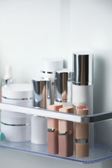 Different cosmetic products on shelf in refrigerator