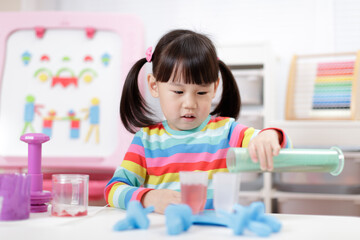 young girl pretend playing food preparing at home