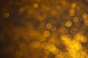 Blurred view of golden lights as background. Bokeh effect